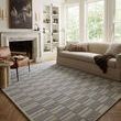 Bradley rug styled in living room setting with sofa and leather chair