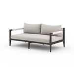 Sherwood sofa angled view with stone grey cushions and low-profile table beside on patio