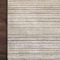Detail close-up of Bellamy Sky Rug texture and pile height variation on dark wood floor