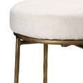 Close-up side view showing textured beige upholstery and rough metal finish of the iron base