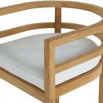 Close-up of chair's rounded armrest and top edge detail with white fabric cushion