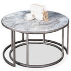 Larger table styled with decorative book and teacup on marble top in bright setting