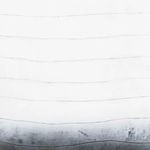 Close-up of the ombre effect and subtle horizontal texture on grey concrete planter