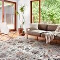 Samra Ivory Multi Rug styled in modern living room with large windows, sofa, and plants