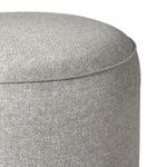 Extreme close-up of fabric texture and stitching on rounded top edge of ottoman