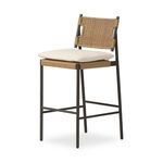 Three-quarter angled view showing woven wicker back and seat with beige cushioned top
