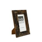 Side angled view showing frame’s thickness and fold-out stand for tabletop display