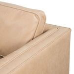 Close-up of back cushion seam and armrest corner showing smooth leather finish