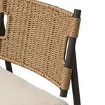 Detail of woven wicker backrest curve with bronzed metal frame support