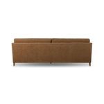 Back view of Lynne Sofa showing smooth brown fabric and slim profile with straight top edge.