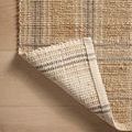 Corner of Judy Natural / Stone Rug flipped over to reveal the woven underside and finishing