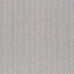 Close view of chair’s armrest side showing detailed stripe fabric and solid washed oak base