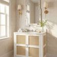 Ariel 2-Door Cabinet styled in a bathroom with wall sconces, mirror, and marble countertop with sink and faucet