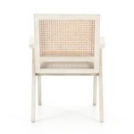 Backside of chair exposing solid oak frame and open woven cane back texture