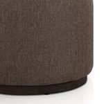 Close-up of the base area showing the rounded dark wood hidden plinth under the fabric