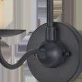 Close-up of round wall plate and curved arm in matte black finish with visible mounting screw