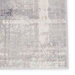 Edge detail and stitched border of Lavato Abstract rug in light gray and cream
