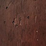 Close-up of wooden swivel base texture with rustic finish and small knots