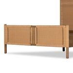 Front view of king bed frame without bedding against white background showcasing woven panels