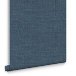 Single wallpaper strip of Rustic Weft rolled down showing subtle textured details and deep blue color.