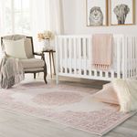 Nursery room view with Malo Medallion rug under crib and pillows, soft pink accent decor