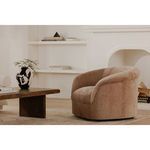 Thora Lounge Chair with rolled arms and soft, textured velvet upholstery in a warm brown tone in a modern living room