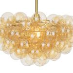 Close-up on the amber glass globes cluster with lit bulbs inside the chandelier
