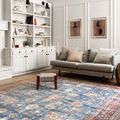 Loren Blue / Brick Rug displayed in a modern living room with grey sofa and white built-in shelves