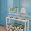Mirasol lamps in three colors on console table with mirror and two white stools with green cushions