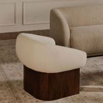 Back angle view of Otto accent chair placed in elegant living room alongside bulky couch