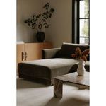 Bryn sectional in living room setting with light carpet, natural light, and decorative vase on table