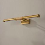 Side view of unlit aged brass picture light on wall focusing on rattan wrap and mounting plate