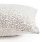 Close-up of pillow zipper against textured off-white fabric edge