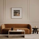 Rosa coffee table in room context with sofa, wall art, side table, and neutral rugs