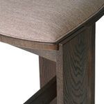 Close-up focusing on seat edge and adjacent oak leg detail