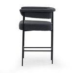 Pair of black boucle bar stools styled with wooden dining table in light room setting