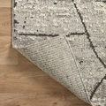 Corner of Fabian Grey Charcoal Rug turned over revealing tightly woven back side and edge binding