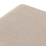 Detail of upholstery corner and wooden base junction on ottoman