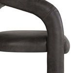 Detailed close-up of armrest edge with visible double-stitched seams in distressed leather
