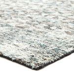 Close-up showing thick wool texture and hand-knotted edges with a mix of gray, black, and subtle blue hues