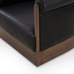 Close-up of lower corner where leather meets ash veneer base showing wood grain detail