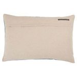 Back of pillow featuring beige fabric with small brand tag near zipper opening