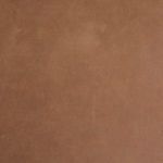 Close-up texture of rich tan leather upholstery on trunk