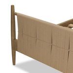 Lower corner of footboard showing woven paper cord panel and tapered parawood leg