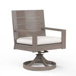 Laguna swivel dining chair in weathered driftwood finish with light beige cushion and aluminum frame