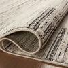 Rolled edge of Darby Charcoal / Sand rug highlighting thick texture and dense weave