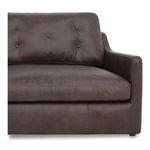 Close-up of seat and back cushions with button tufting and smooth armrest detail