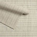 Partially rolled edge showing flexible wool construction with visible stripe alignment and weave
