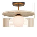 Apricity Semi-Flush Mount with frosted white glass globe and flat round travertine disc in antique brass finish