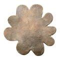 Bird’s-eye view focusing on oxidized gold flower-shaped tabletop with textured surface